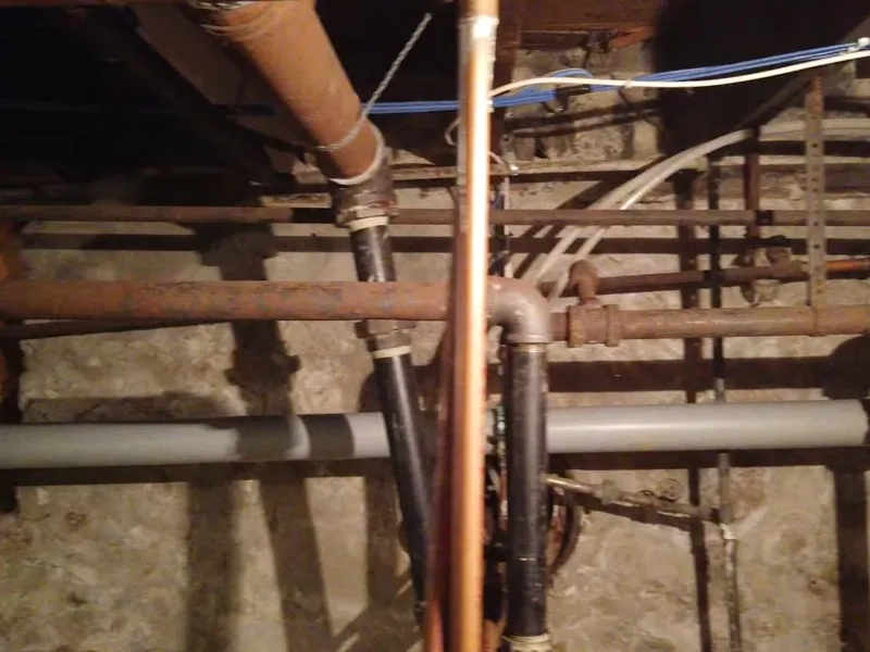 Basement rough-in, utility sink, or exposed piping for Sewage ejector pump basin
