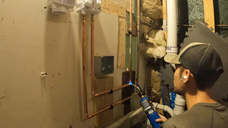 Basement rough-in, utility sink, or exposed piping for Sump pump pit and battery backup in a Stonegate finished basement