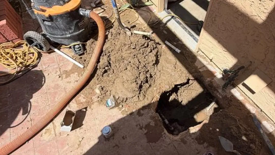 Opened concrete slab and under-floor pipe repair area for Leak detection in Parker