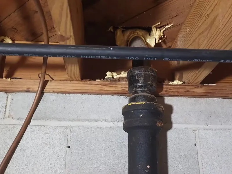 Sewer pipe, trench, cleanout, or cast iron repair area for PEX replacing galvanized pipe