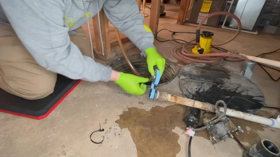Sump pump pit, basin, and discharge piping for Battery backup sump pump in a Parker home