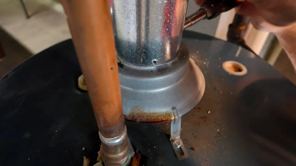 Tank water heater and plumbing connections for Parker plumber inspecting a water heater in a Lincoln Creek home