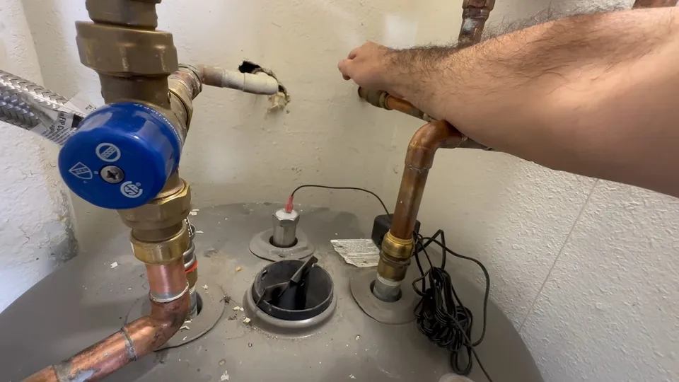 Tank water heater and plumbing connections for Private well pressure tank system at a Pinery large-lot home
