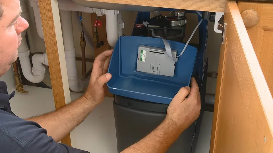 Water softener control head, tank, and brine components for Plumber clearing a drain in a Saddlebrook Parker home