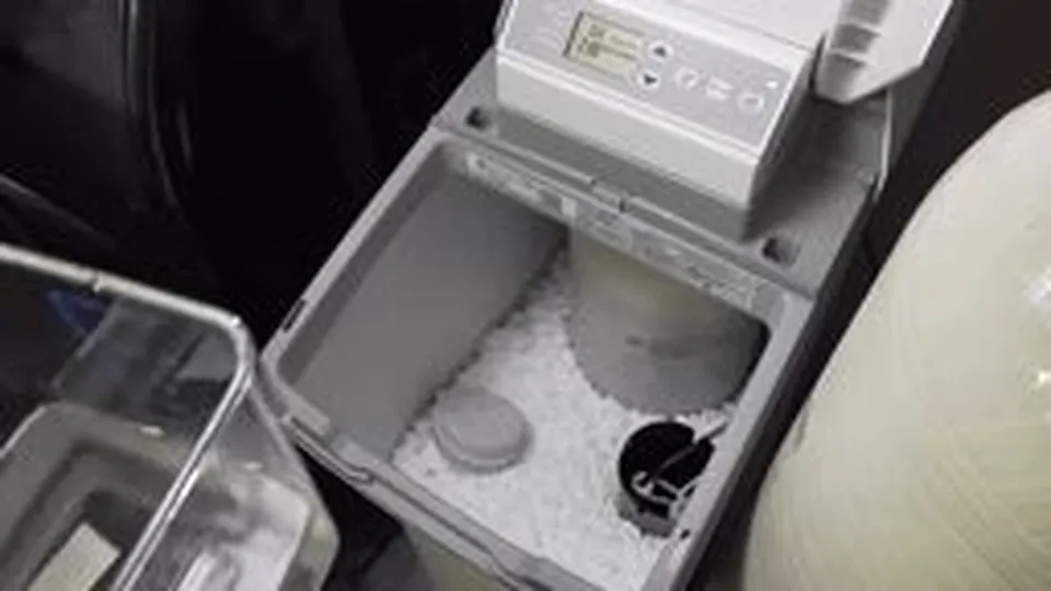Water softener control head, tank, and brine components for Water softener system installed in a Pinery home utility room